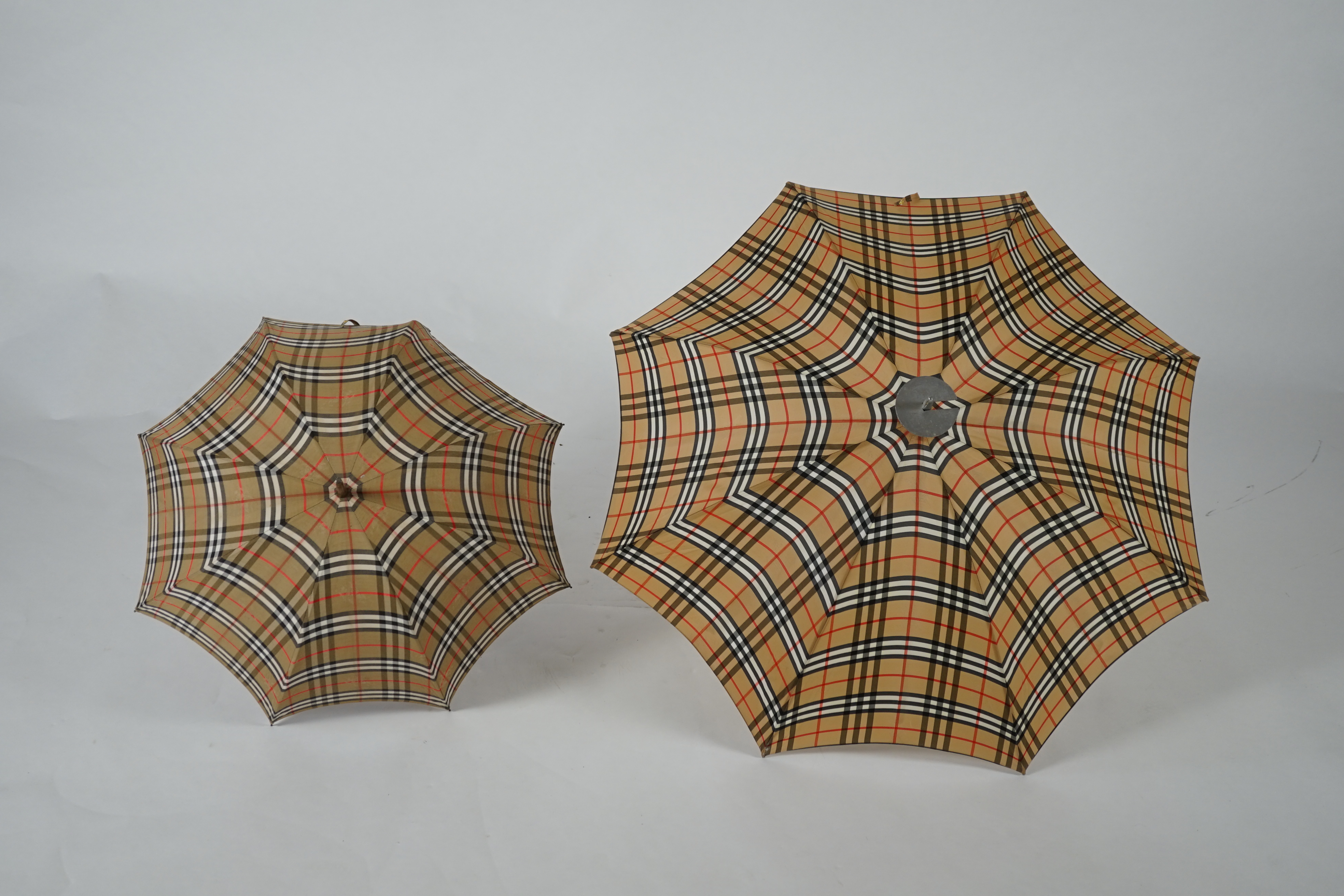 A vintage Burberry shooting stick umbrella and a lady's vintage cotton umbrella, shooting stick height 91cm, umbrella 83cm